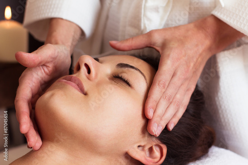 Face Massage. Close-up of a beautiful Woman Getting Spa Treatmen