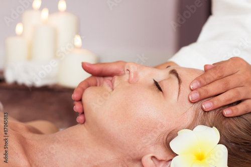 Face Massage. Close-up of a beautiful Woman Getting Spa Treatmen