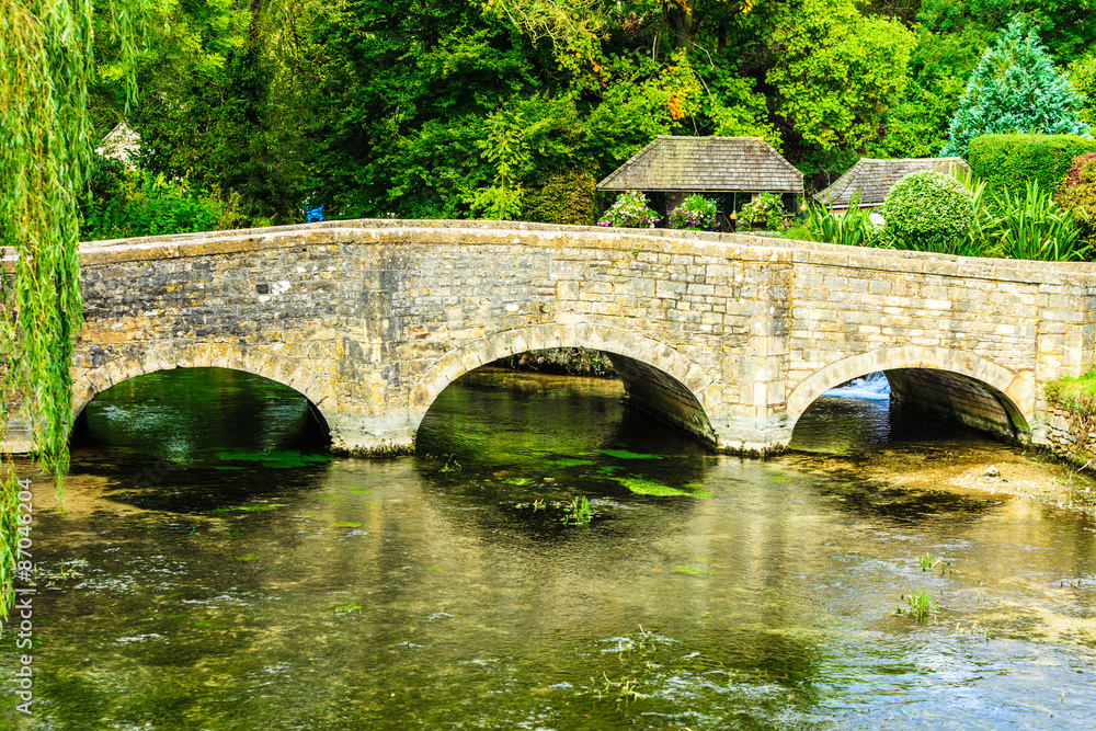 Old bridge over river Coln in village Bibury England