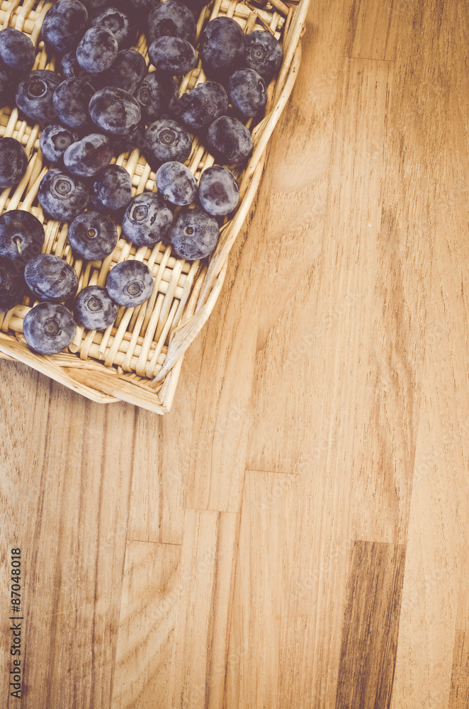 fresh and ripe blackberries in a wicker canister on a natural wood surface fresh and ripe blackberries in a wicker canister on a natural wood surface