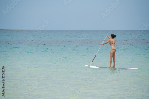 Girl paddling out on paddle board