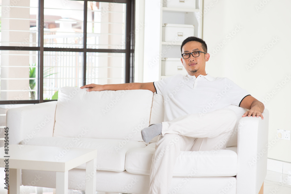 asian man sitting on sofa