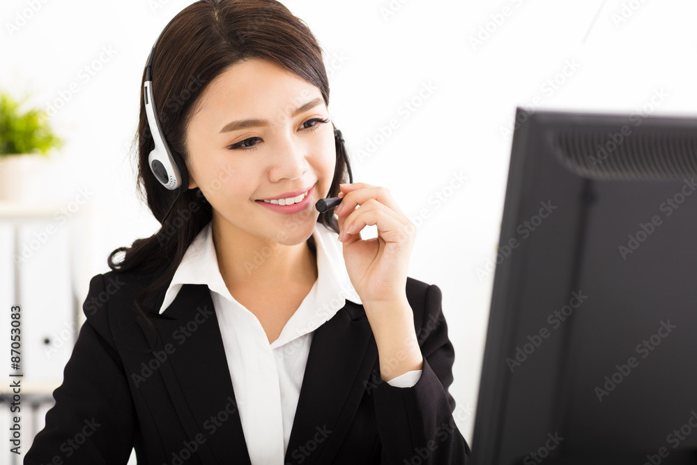 young beautiful business woman with headset in office young beautiful business woman with headset in office