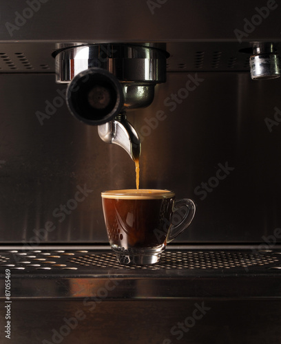 Hot coffee flow to a cup on espresso machine