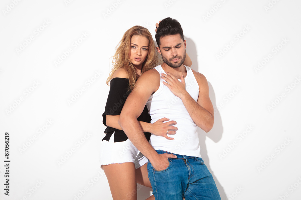 Young casual man holding his hand on his chest Young casual man holding his hand on his chest