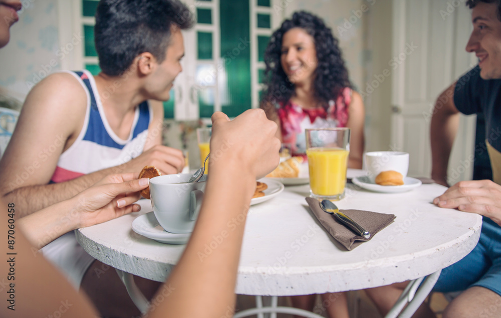 Group of young friends having breakfast at home Group of young friends having breakfast at home