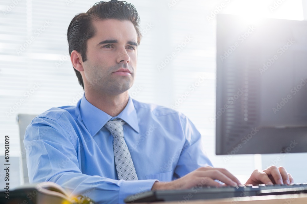 Serious businessman using computer Serious businessman using computer