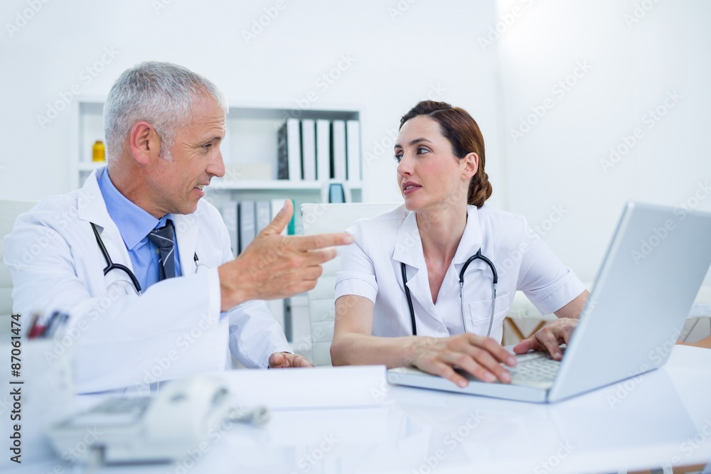 Concentrated medical colleagues discussing and working together Concentrated medical colleagues discussing and working together