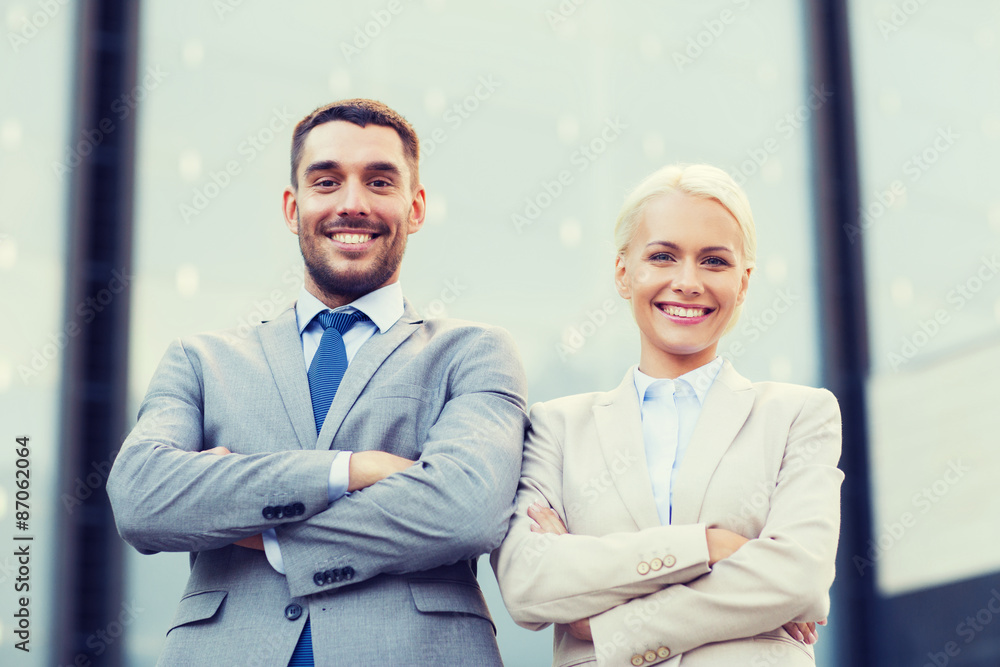 smiling businessman and businesswoman outdoors smiling businessman and businesswoman outdoors
