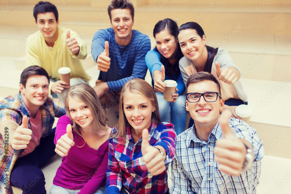 group of smiling students with paper coffee cups group of smiling students with paper coffee cups