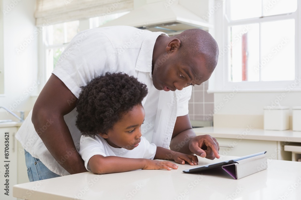 Father and son using digital tablet Father and son using digital tablet