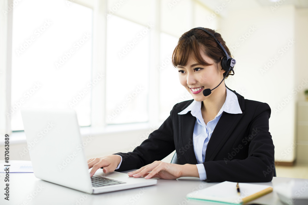 young beautiful businesswoman with headset in office young beautiful businesswoman with headset in office