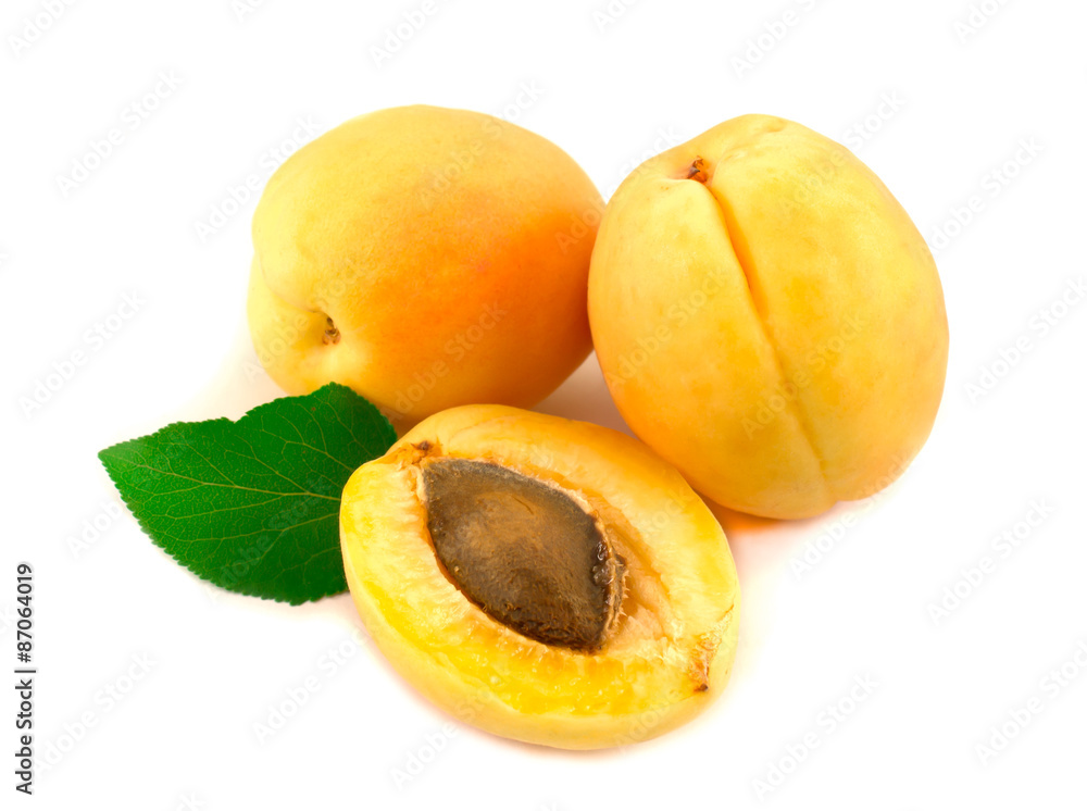 Apricots with leaves on a white background.