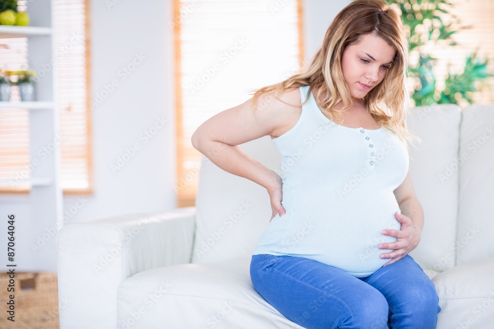 Pregnant woman getting a contraction Pregnant woman getting a contraction