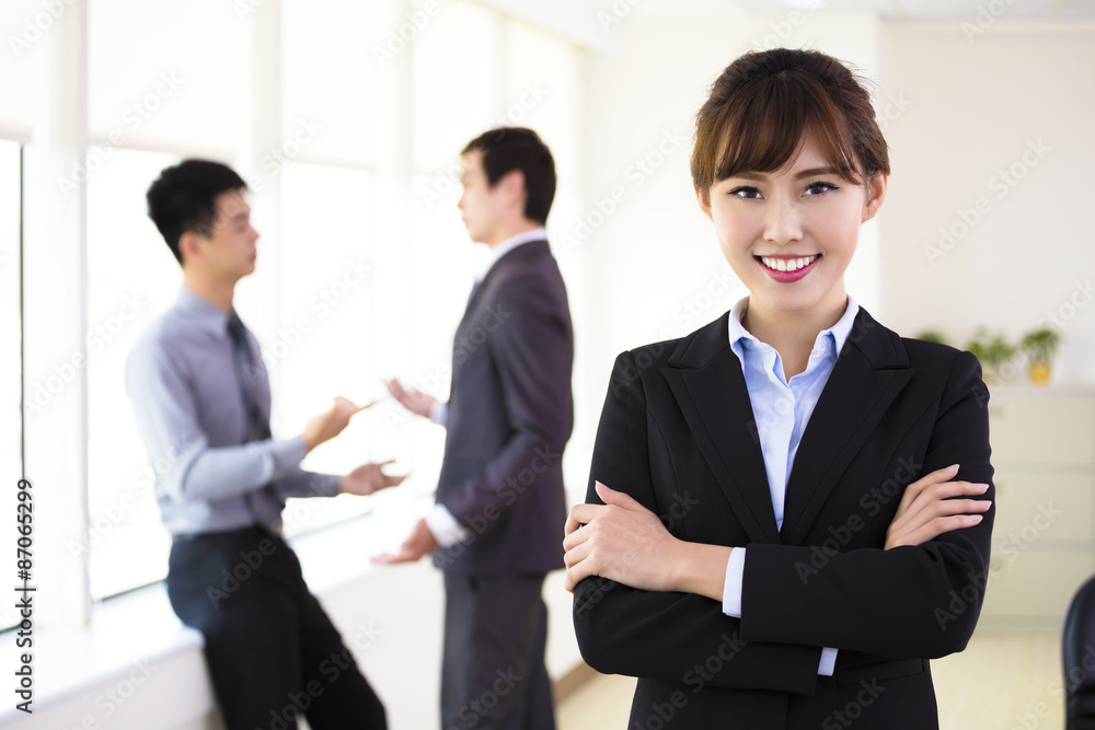 smiling young business woman standing in office smiling young business woman standing in office