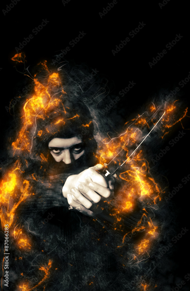 Hooded person with Ninja Knife in fire. Hooded person with Ninja Knife in fire.