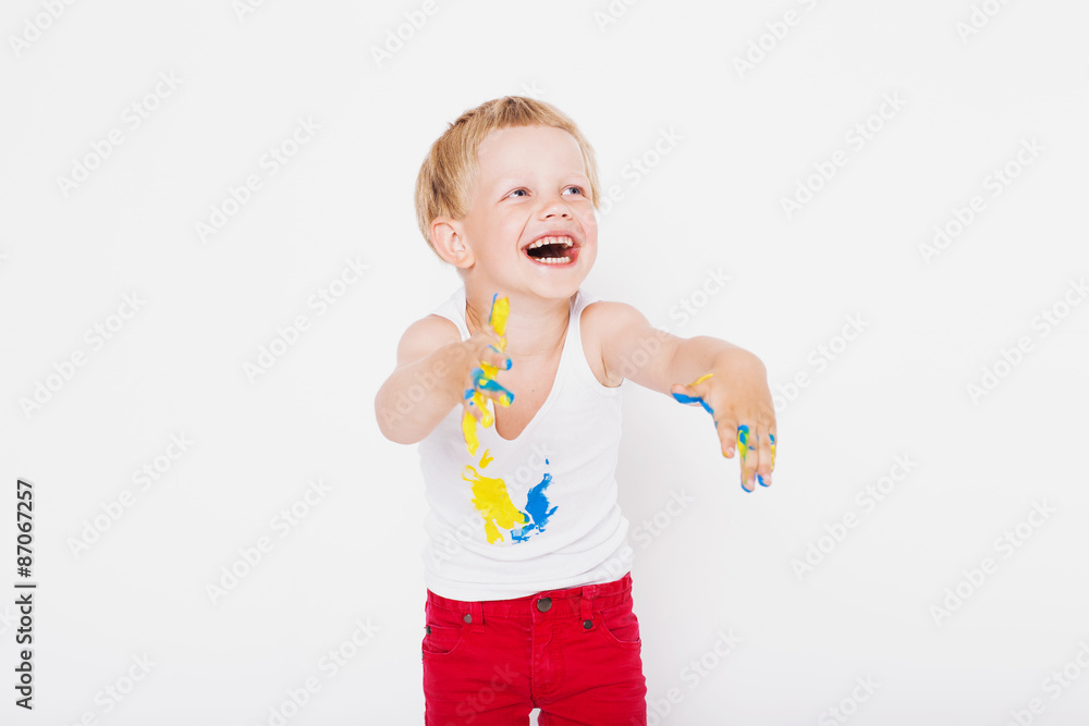 Boy with hands painted in colorful paints ready to make hand prints Boy with hands painted in colorful paints ready to make hand prints