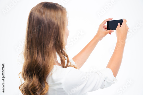 Woman making photo on smartphone