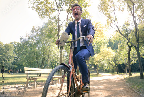 Fotografía Joyful businessman riding in the park