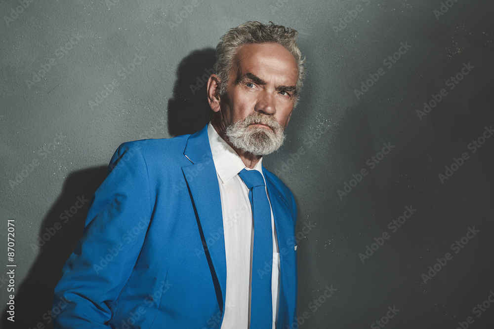 Serious Matured Businessman Leaning Against Wall Serious Matured Businessman Leaning Against Wall