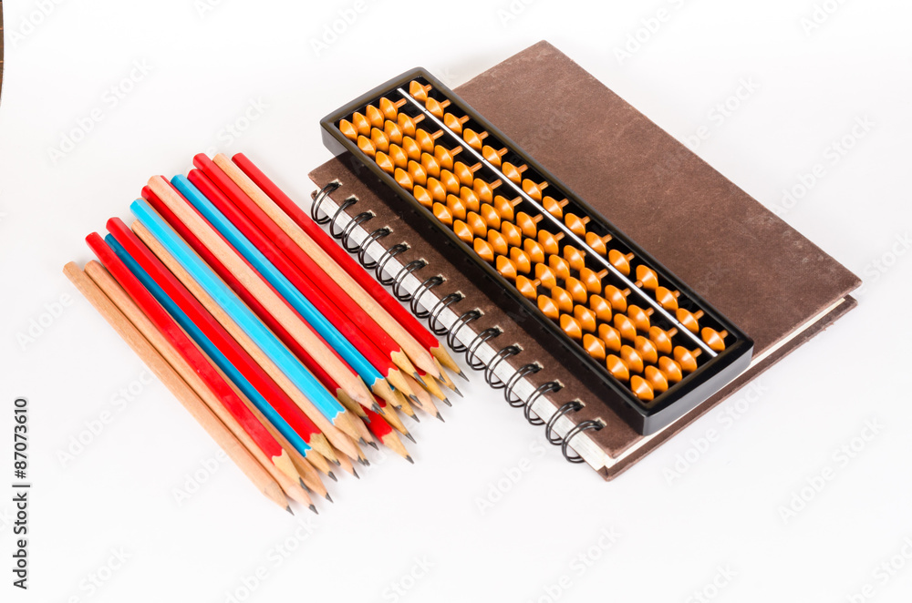 Notebook with abacus and wooden pencil isolated on white backgro Notebook with abacus and wooden pencil isolated on white backgro