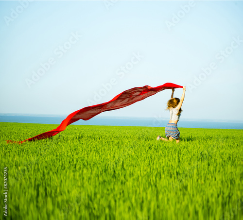 Young happy woman in wheat field with fabric. Summer lifestyle