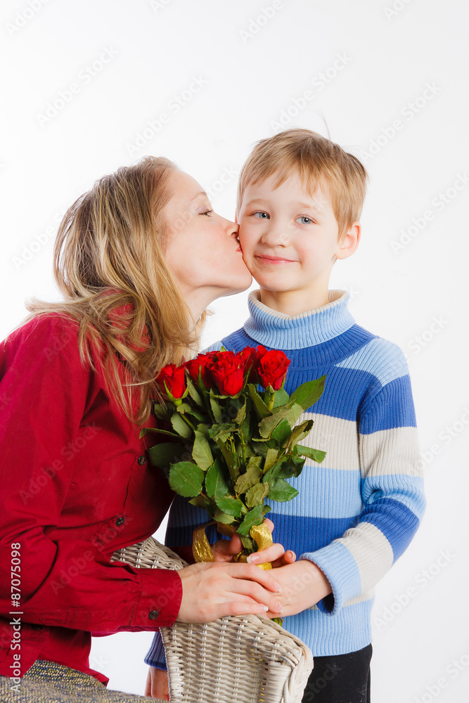 Young beautiful woman kissing her son Young beautiful woman kissing her son