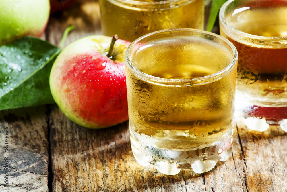 Cold apple juice and fresh apples on an old wooden table, select Cold apple juice and fresh apples on an old wooden table, select