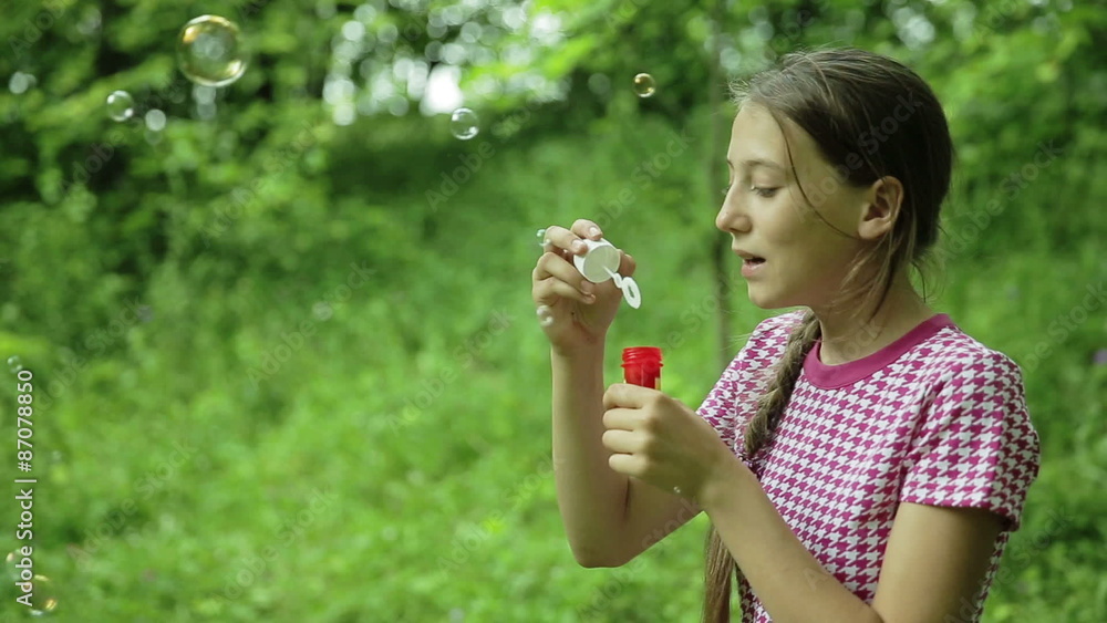 Young girl blowing soap bubbles outdoor Young girl blowing soap bubbles outdoor