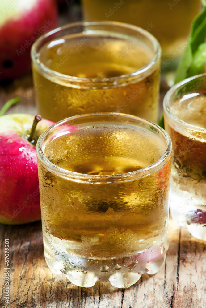 Cold apple juice and fresh apples on an old wooden table, select Cold apple juice and fresh apples on an old wooden table, select