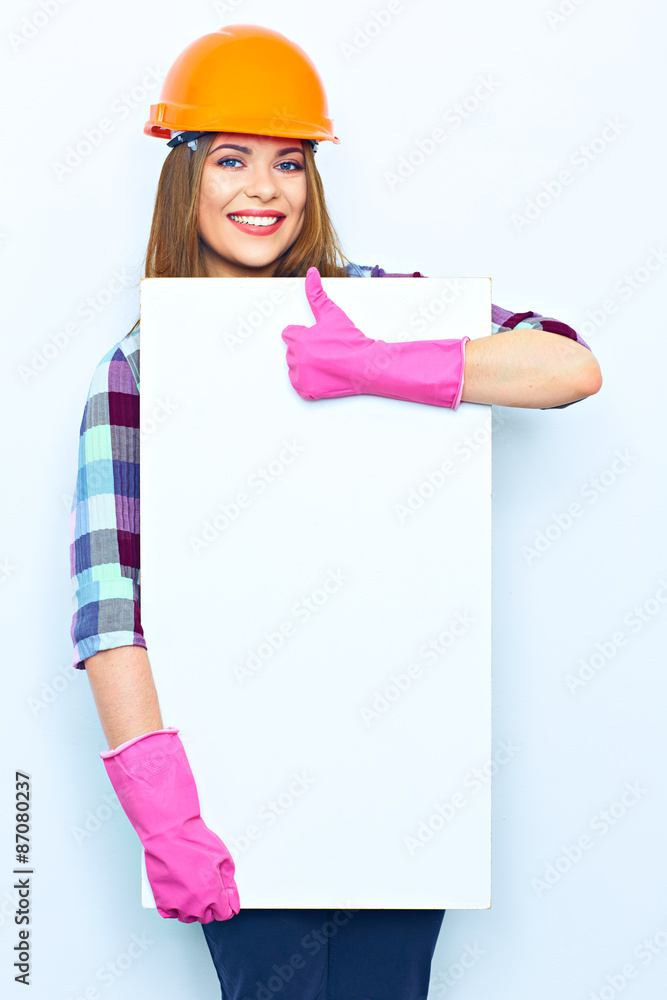 Woman worker builder holding big sign board against show thumb Woman worker builder holding big sign board against show thumb
