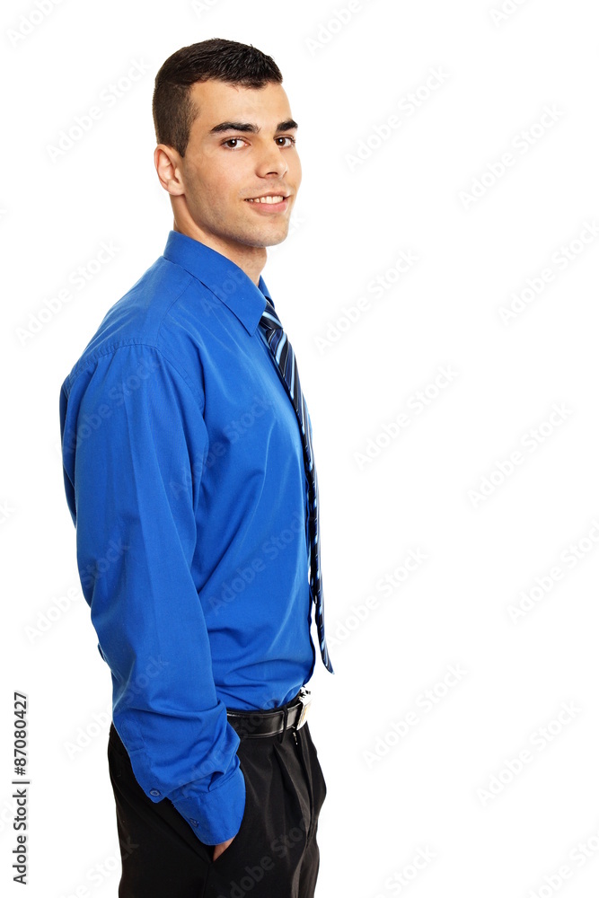 Young businessman in blue shirt with hands in pockets Young businessman in blue shirt with hands in pockets