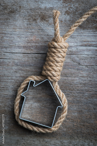 Small house framed with hangman's noose over the old wooden surface