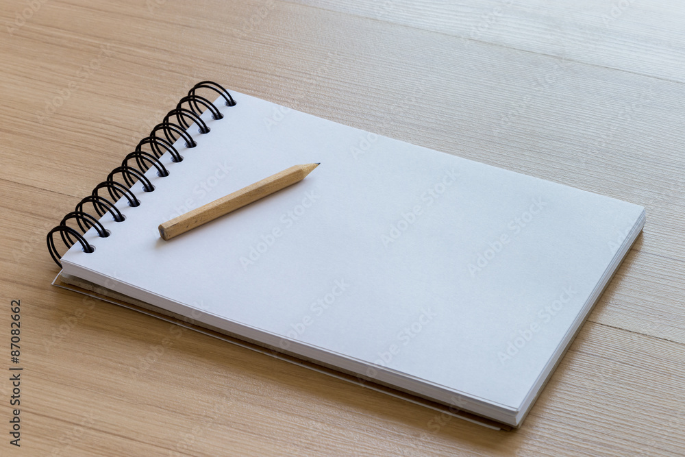 Wood Pencil Placed on a Blank Notebook Wood Pencil Placed on a Blank Notebook