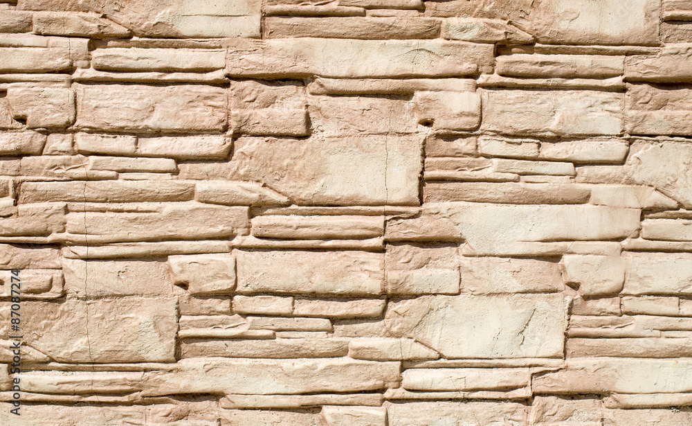 Decorative relief cladding slabs imitating stones on wall Decorative relief cladding slabs imitating stones on wall