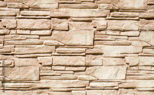 Decorative relief cladding slabs imitating stones on wall