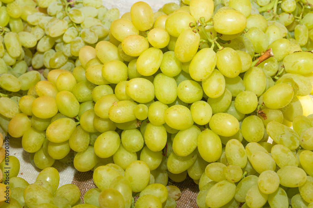 Fresh white grapes on an open air fruit market stand.
