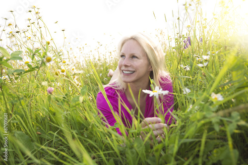 Beautiful woman enjoying daisy in a field