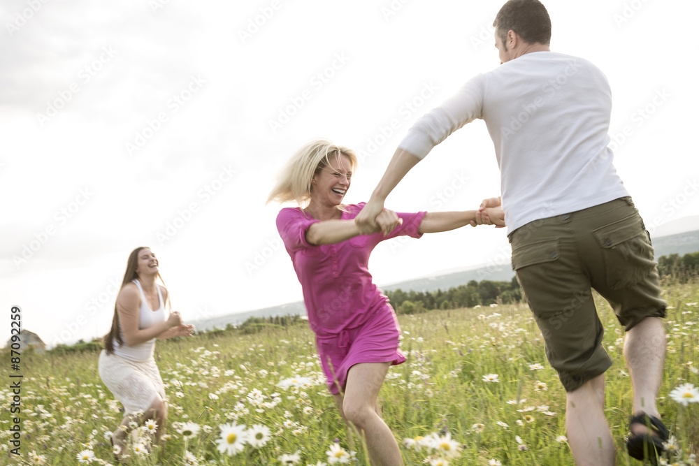 happy friends spending free time together in a field happy friends spending free time together in a field
