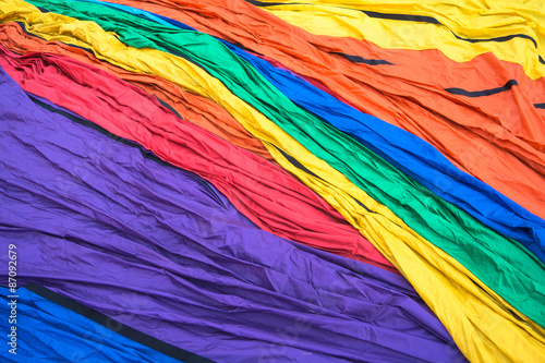 brightly colored nylon fabric from hot air balloon laid out on the ground ready to inflate for launching