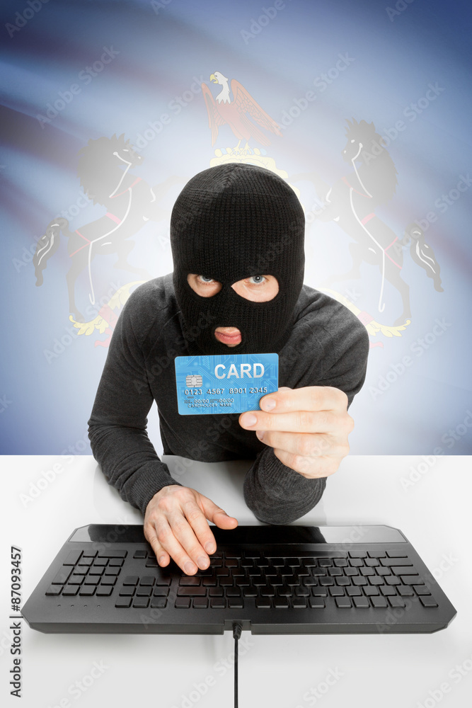 Hacker holding credit card with US state flag on background - Pennsylvania Hacker holding credit card with US state flag on background - Pennsylvania