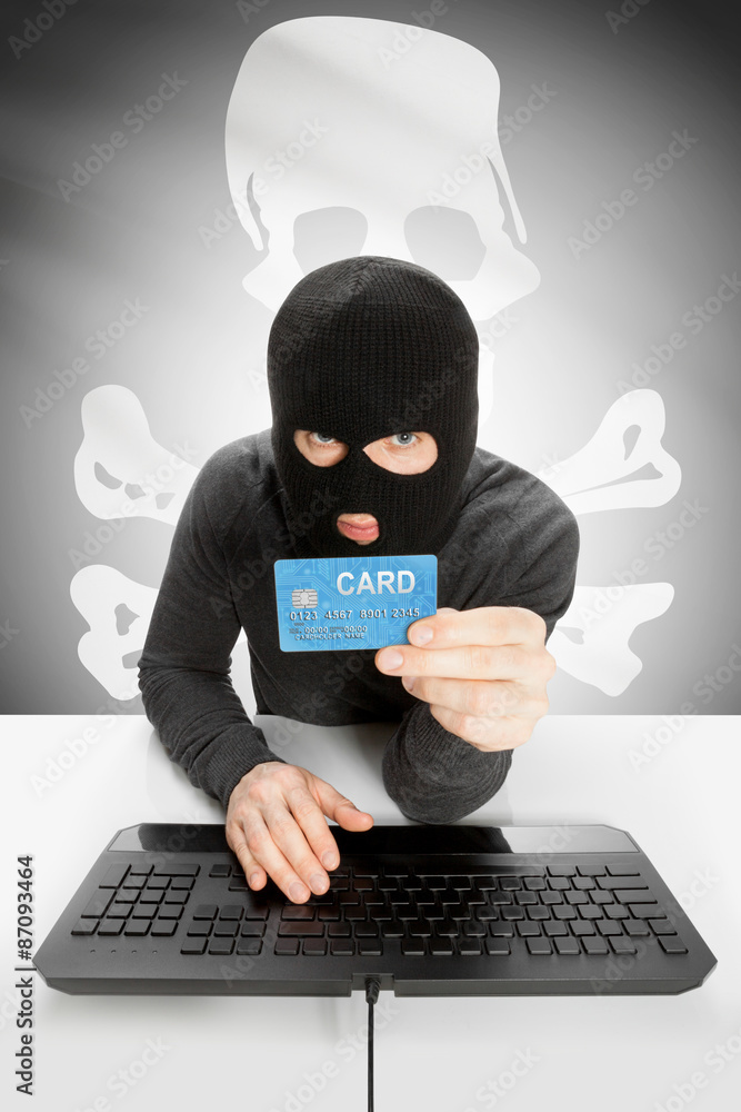 Hacker holding credit card with US state flag on background - Jolly Roger Hacker holding credit card with US state flag on background - Jolly Roger
