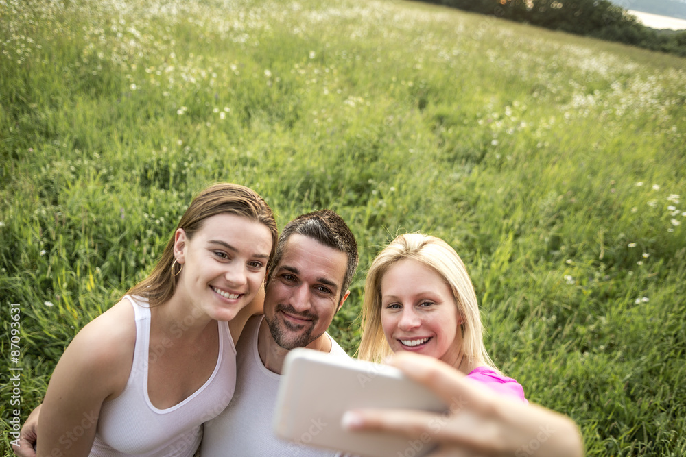 happy friends spending free time together in a field happy friends spending free time together in a field