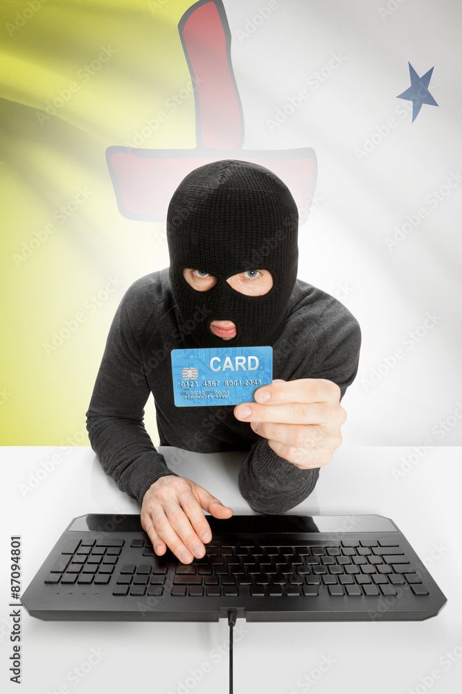 Hacker with credit card in hand and Canadian province flag on background - Nunavut Hacker with credit card in hand and Canadian province flag on background - Nunavut
