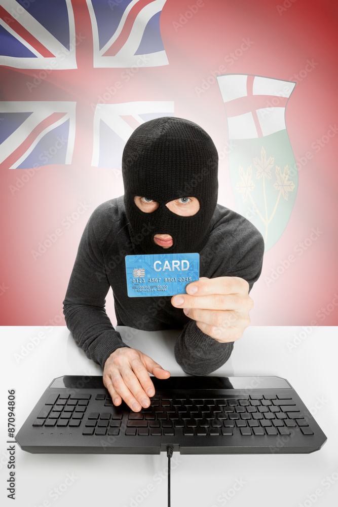 Hacker with credit card in hand and Canadian province flag on background - Ontario