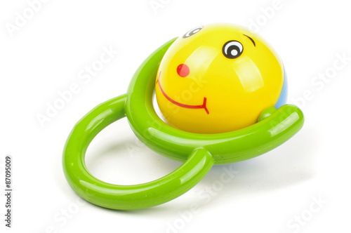 Φωτογραφία Baby toy with smile and green handle isolated on the white background