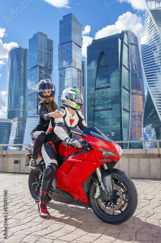 One guy and sexy girl in a suit with a motorcycle sport bike © Andrey_Arkusha