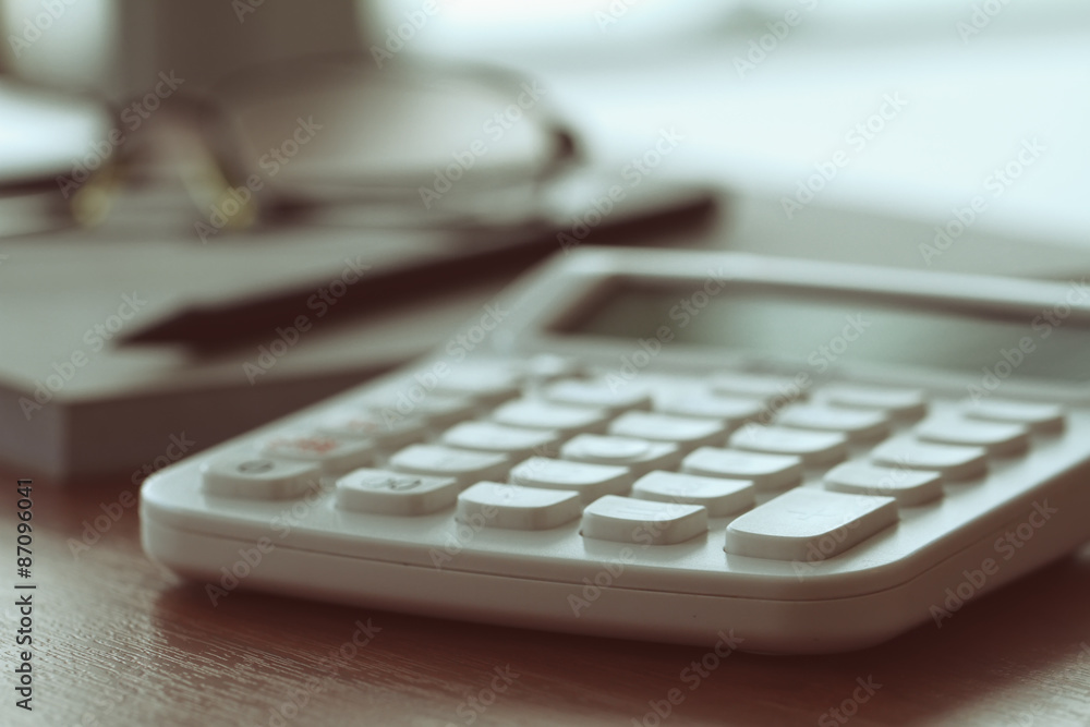 business documents on office table with calculator and digital t business documents on office table with calculator and digital t