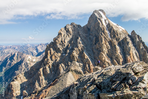 hiker in jagged granite peaks