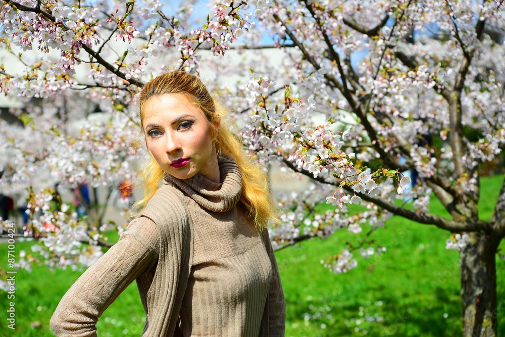 Young girl posing in the sakura garden Young girl posing in the sakura garden